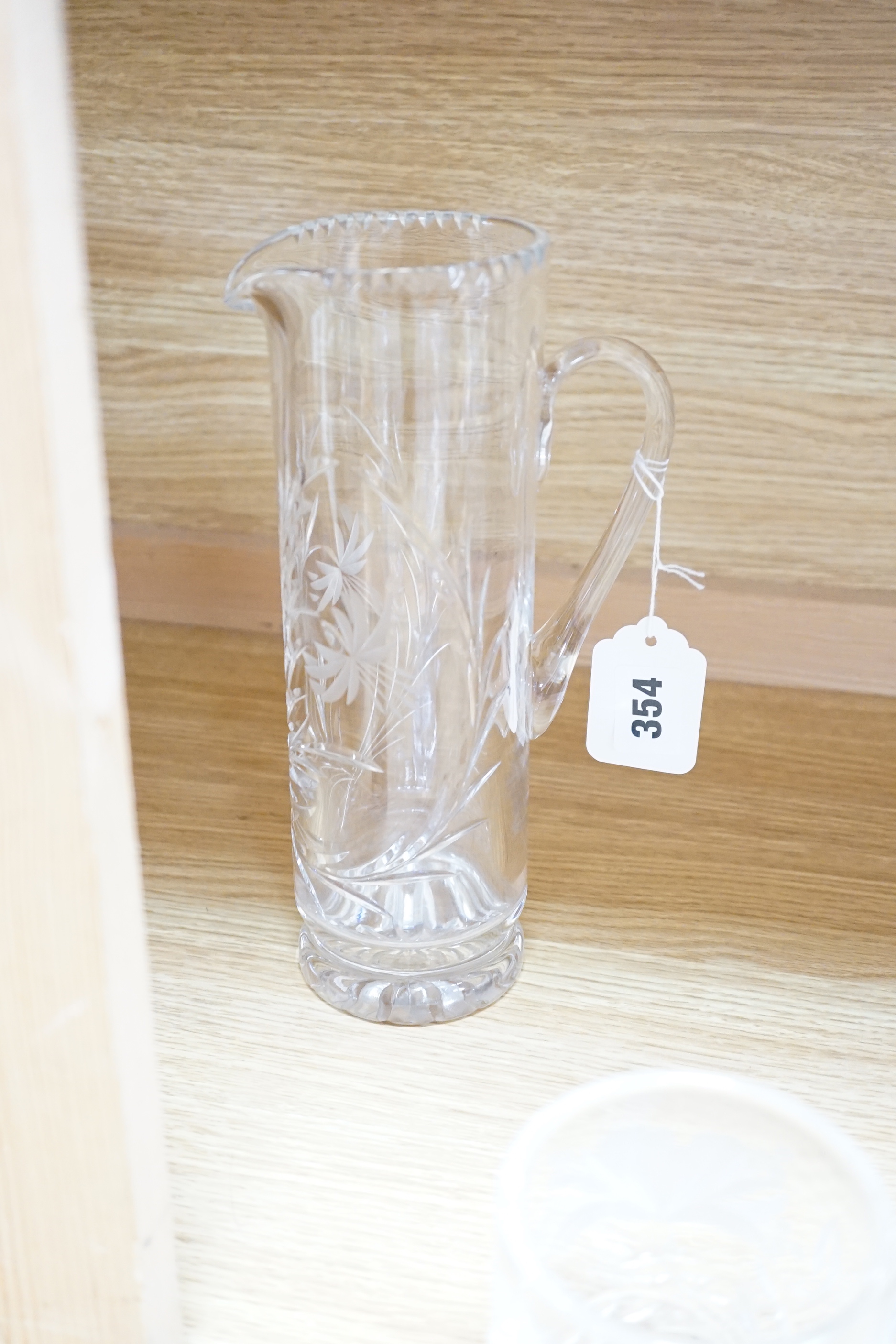 Two deep cut glass jugs, a cylindrical vase, two circular footed bowls and a tankard (6)